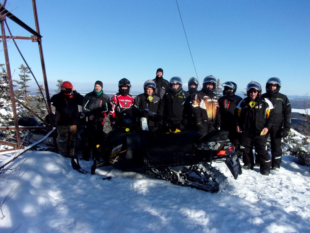 Twelve Easy Riders on the top of the JoMary Lookout Millinocket Trip – Feb 2020